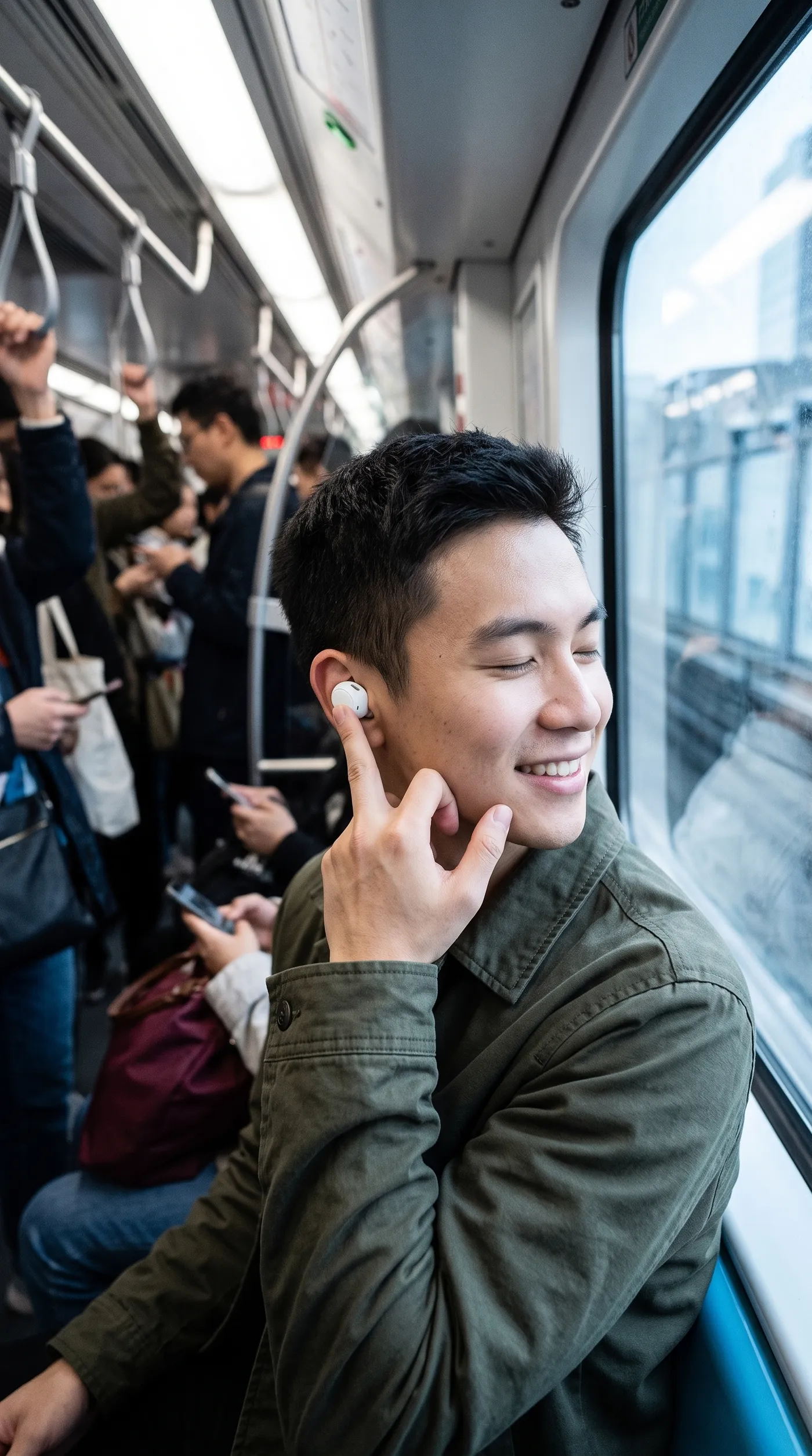 Vertical opening frame of a man on a train closing his eyes and smiling as he touches a white earbud in his ear, 9:16 hook variation created with getimg.ai from a product reference