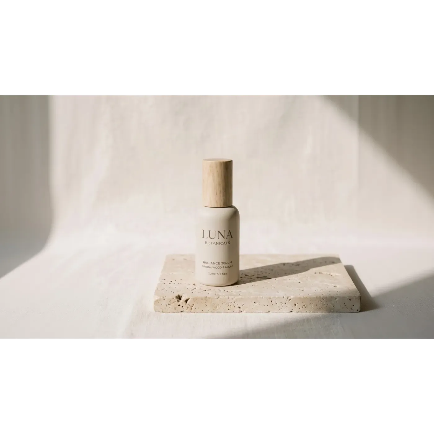 The same ceramic serum bottle at the same height with the frame extended sideways to 16:9 and new linen backdrop generated left and right, leaving space for headline copy, created with Outpainting on getimg.ai.