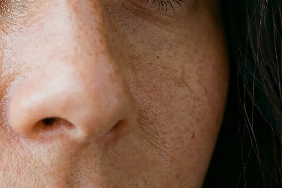 The same portrait crop after a 4K upscale with Topaz Bloom 2, with added pores and fine hairs