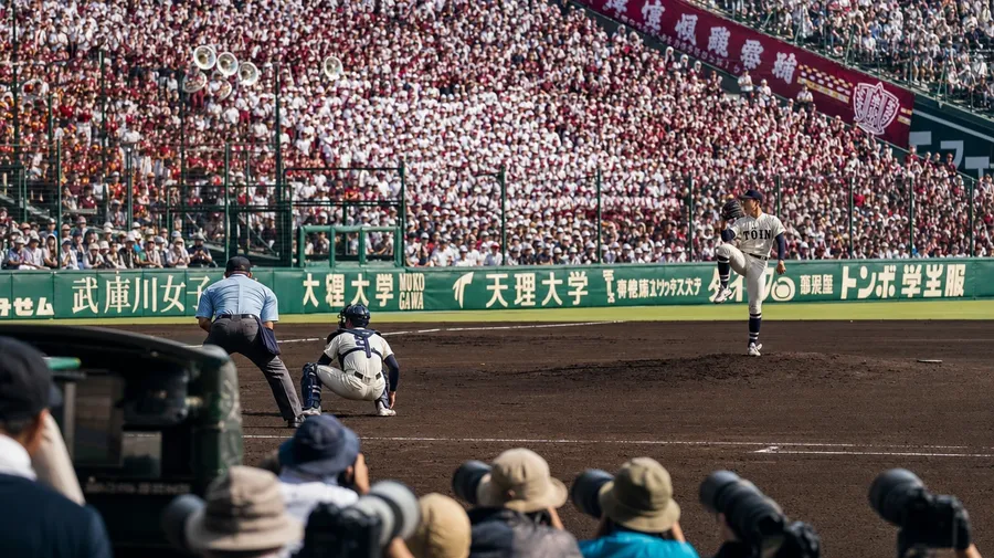 Koshien tournament final at Hanshin Stadium with student bands and packed grandstand, AI-generated stock baseball image.