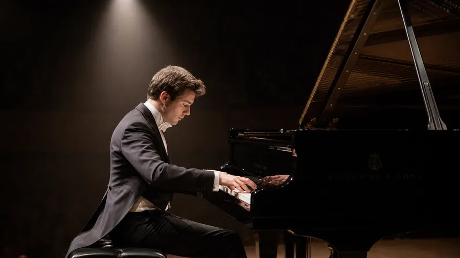 AI-generated concert grand pianist in tails mid-recital under a single warm spotlight on a darkened hall stage.