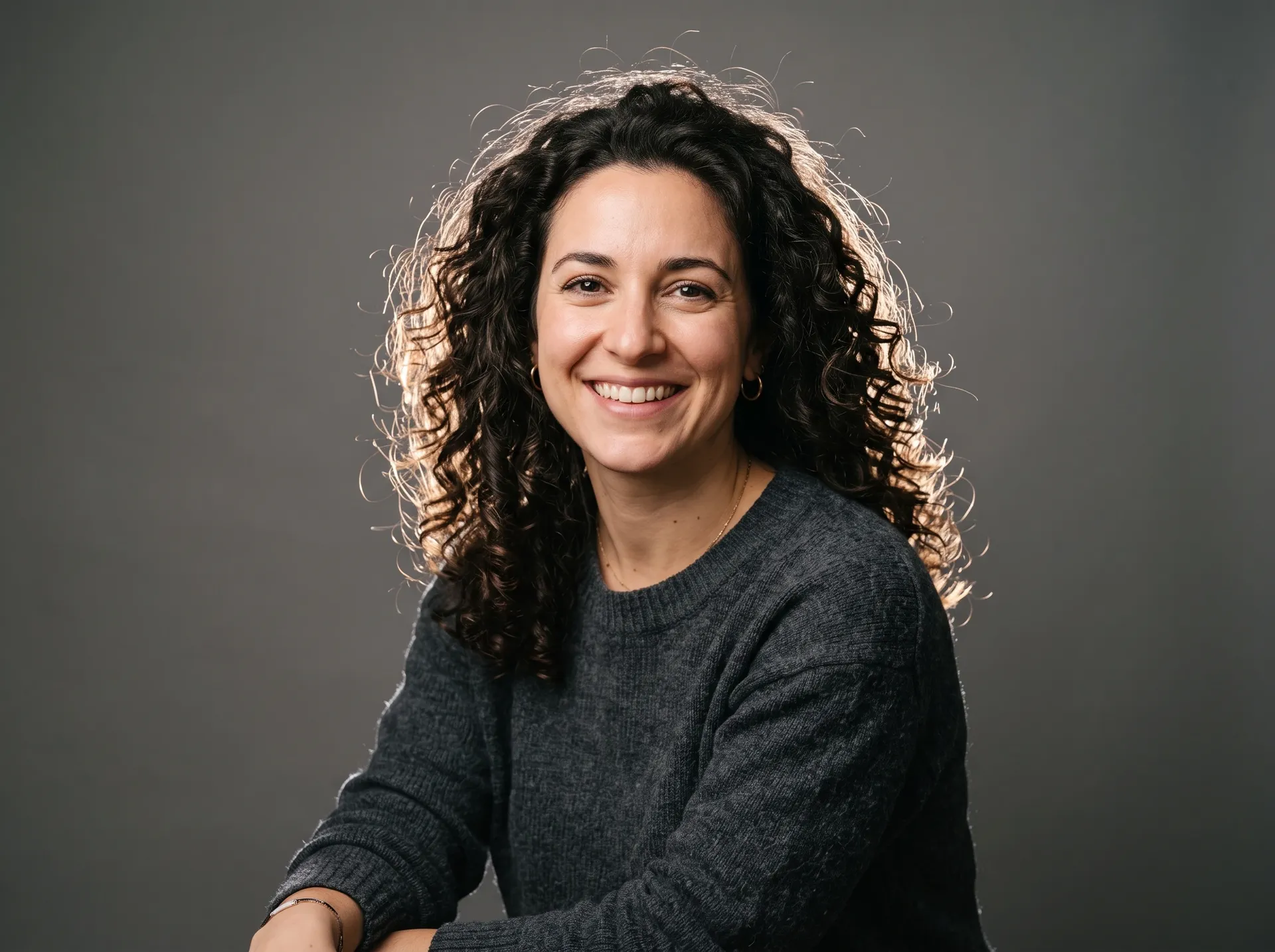 Backlit studio portrait with visible flyaway hair strands, the source photo for the getimg.ai background change test