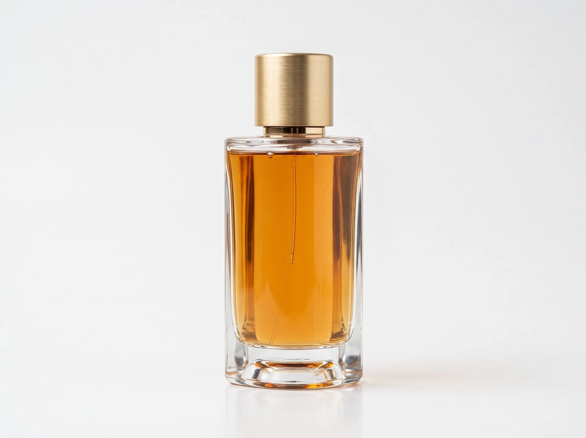 Glass perfume bottle on a white studio sweep, the source photo for the getimg.ai background change test