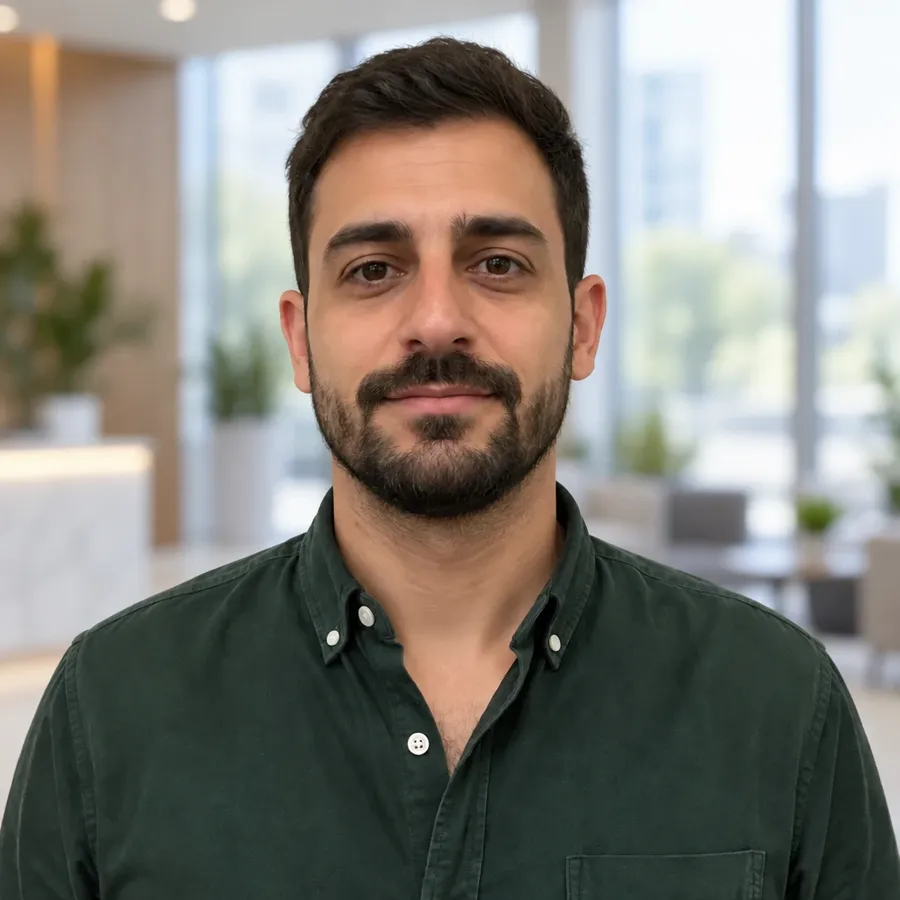 Man in a green shirt in a modern office lobby, one of four backgrounds from one source photo on getimg.ai