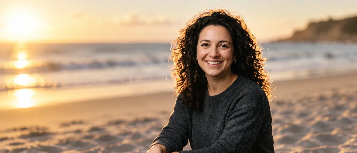 Same source portrait on a sunlit late-afternoon beach, one of eight backgrounds generated on getimg.ai