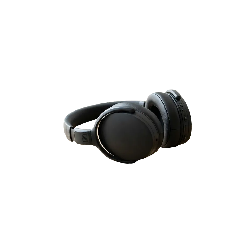 Matte black wireless over-ear headphones cut out from an oak desk photo onto a transparent background, generated and cut out with getimg.ai