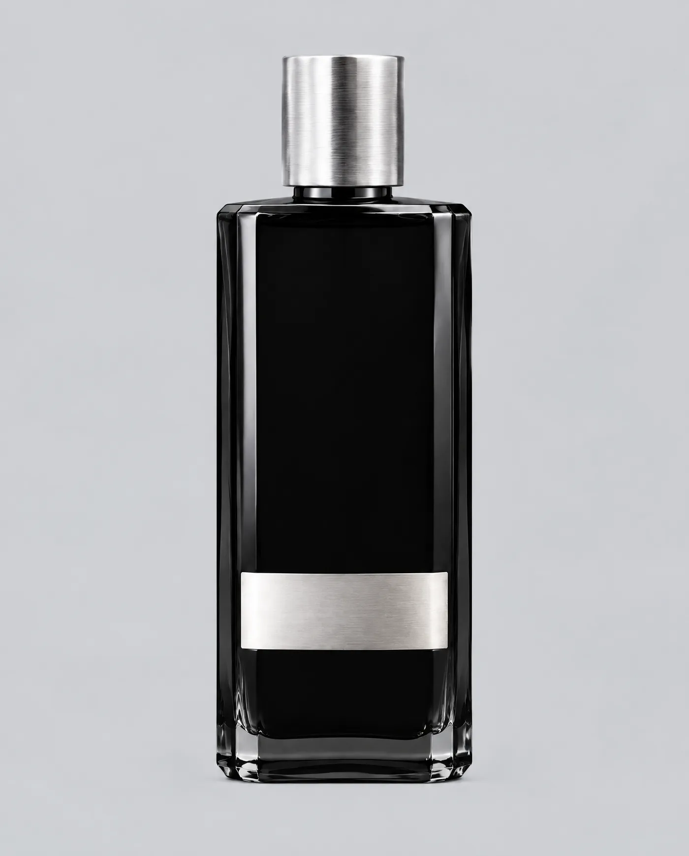 A single black glass fragrance bottle with a brushed silver cap and a blank silver label band, on a plain grey studio background. Shown as the clean, easy-to-read product reference image that anchors an entire AI product photography campaign. Generated with getimg.ai.