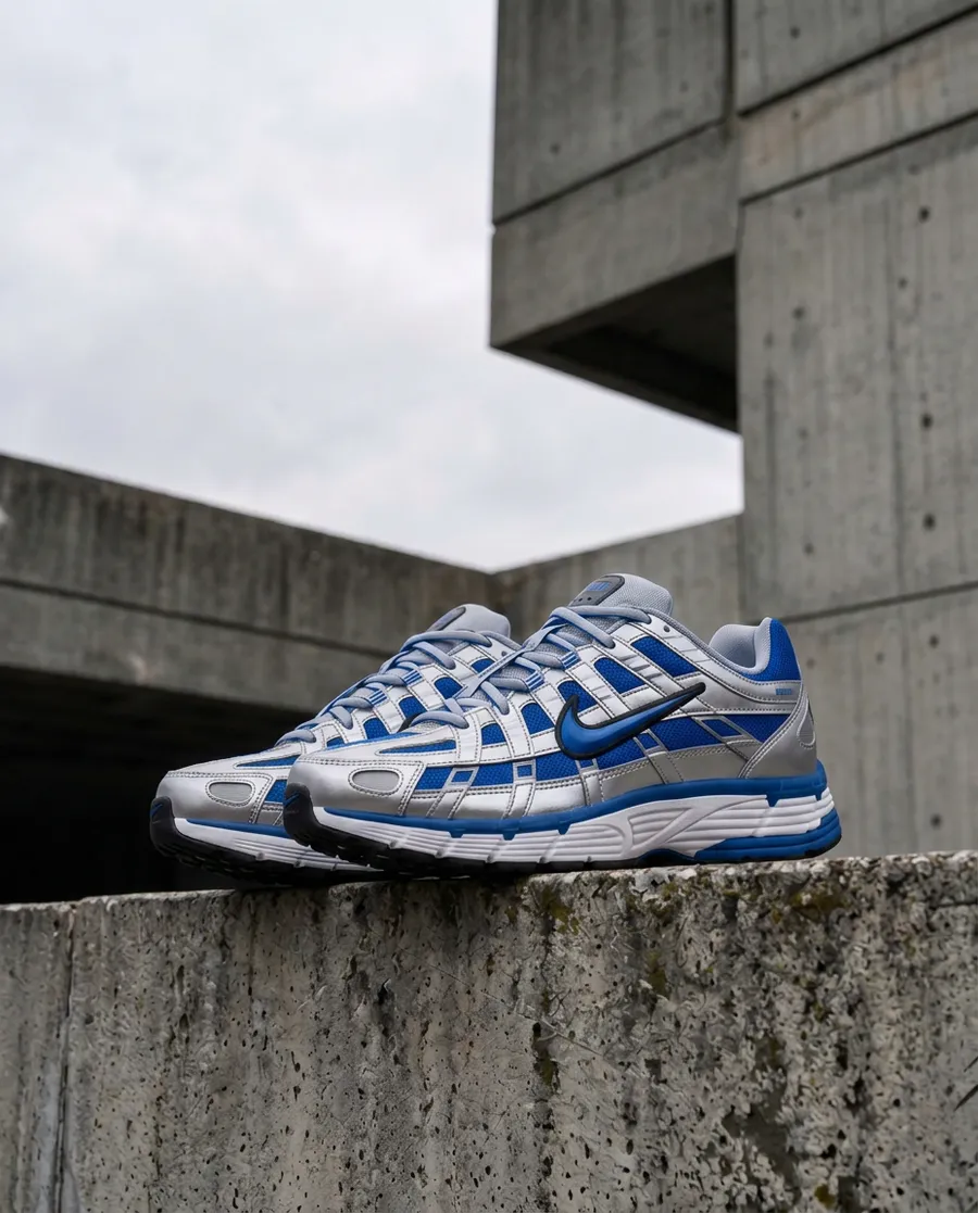 photo of blue-and-white running sneakers on a weathered concrete ledge in a brutalist architectural setting, used as the editing reference on getimg.ai