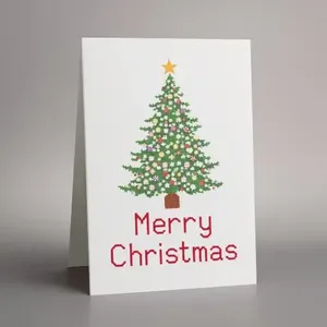 White Christmas card with a decorated green tree and red Merry Christmas lettering.