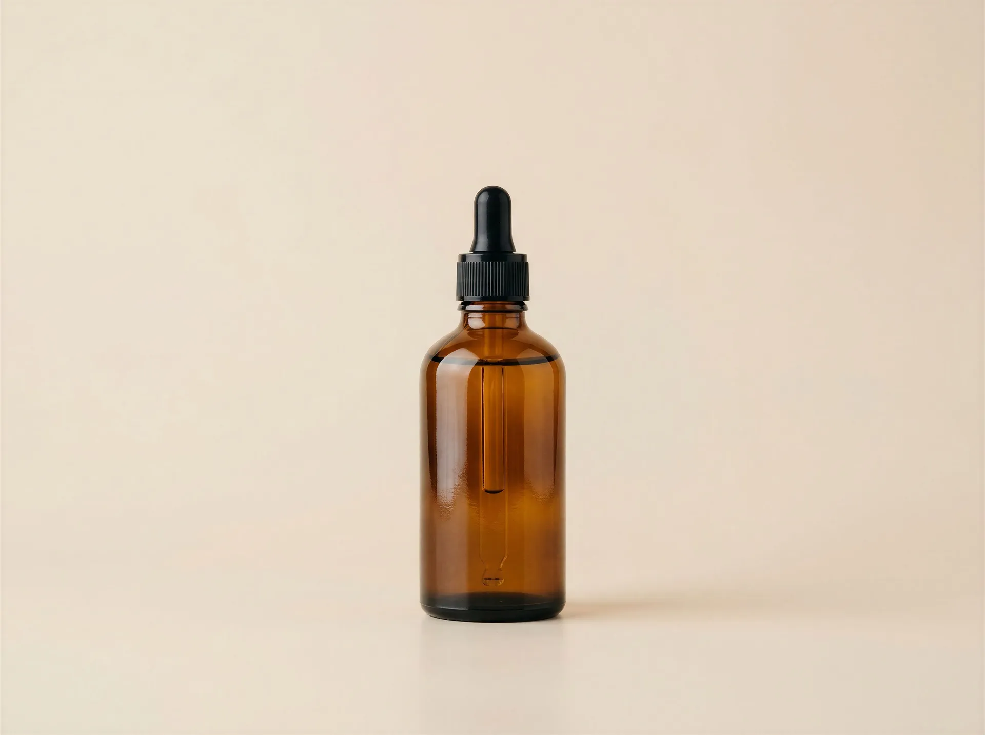 An amber glass dropper bottle centred on a plain cream backdrop with wide empty space above and below it, ready to be recropped. Step five of a team campaign, where the social manager resizes the finished assets for Reels, Stories and feed. Image generated with getimg.ai.