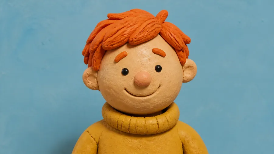 Claymation-style avatar of a cheerful orange-haired figure in a yellow turtleneck, made on getimg.ai