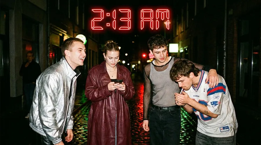 Flash night photo of four friends leaving a club under a red 2:13 AM neon sign in a rain-soaked alley, generated on getimg.ai with Nano Banana Pro for an AI image realism test.