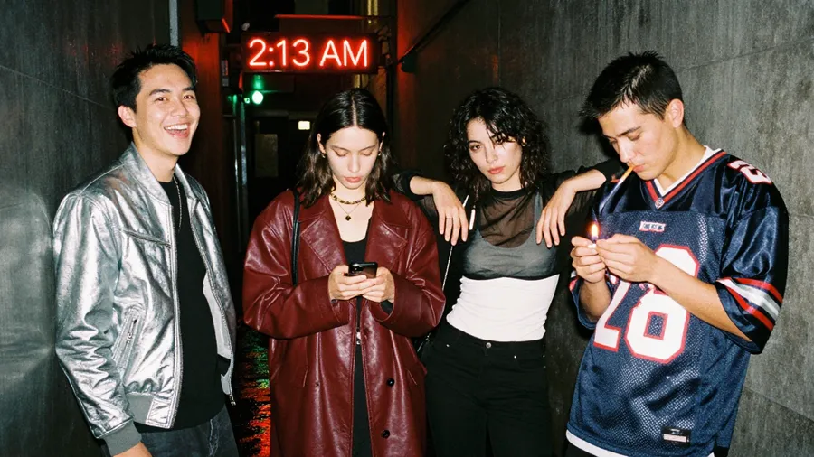 Flash night photo of four friends leaving a club under a red 2:13 AM neon sign in a rain-soaked alley, generated on getimg.ai with Z-Image Turbo for an AI image realism test.
