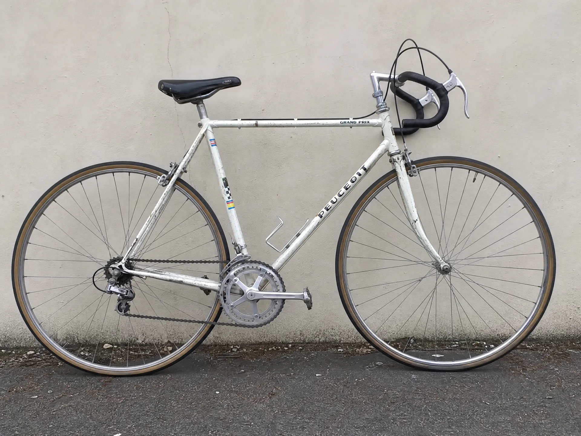 Photograph of a vintage bicycle against a wall