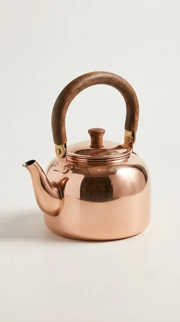 Product photo of a polished copper kettle with a curved wooden handle, generated on getimg.ai and used as an image reference to replace an object in a video
