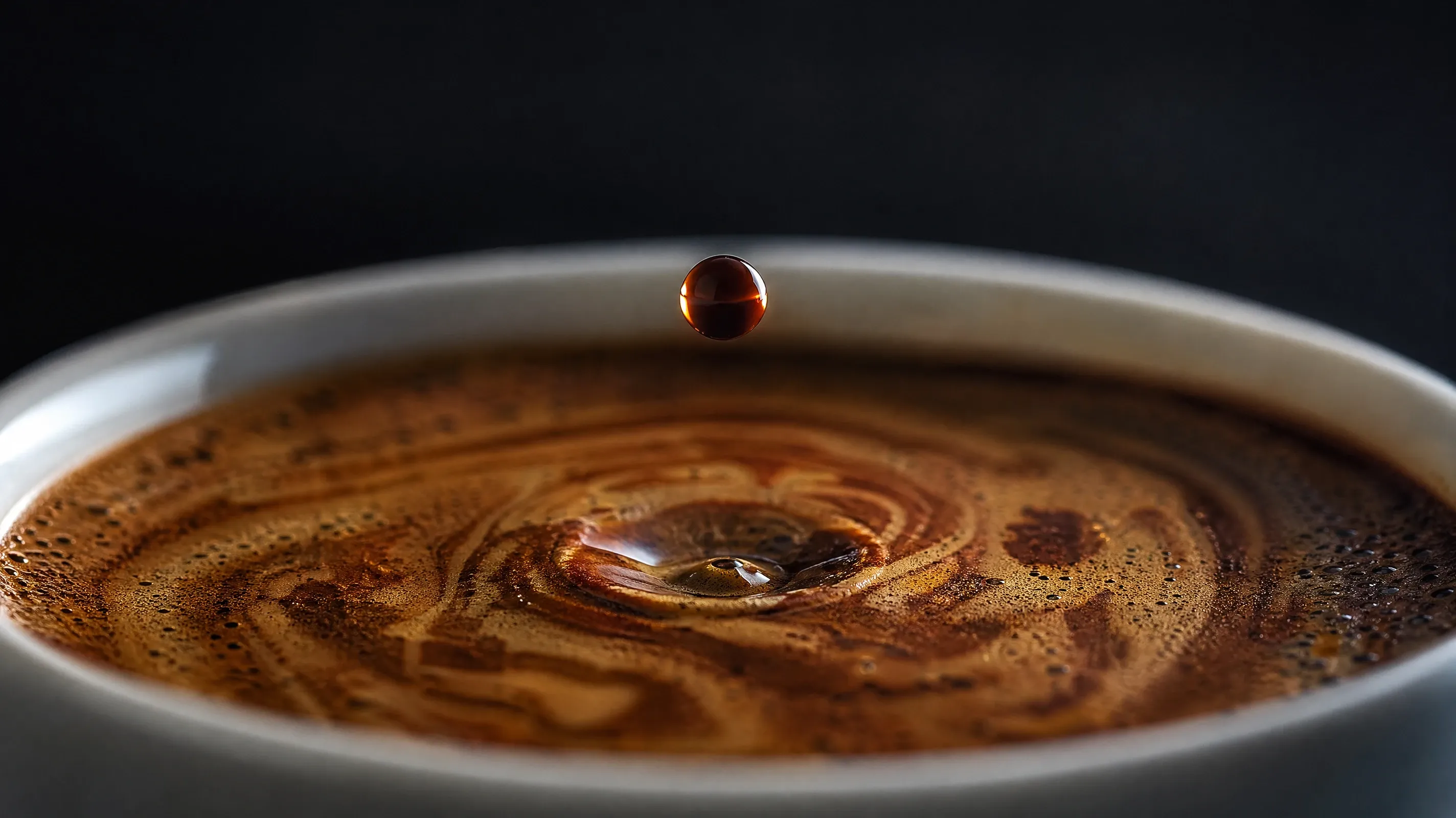 AI macro photography stock of a dark espresso droplet about to land on tiger-stripe crema in a porcelain cup