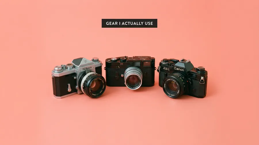 Editorial 16:9 thumbnail of centered vintage cameras on coral